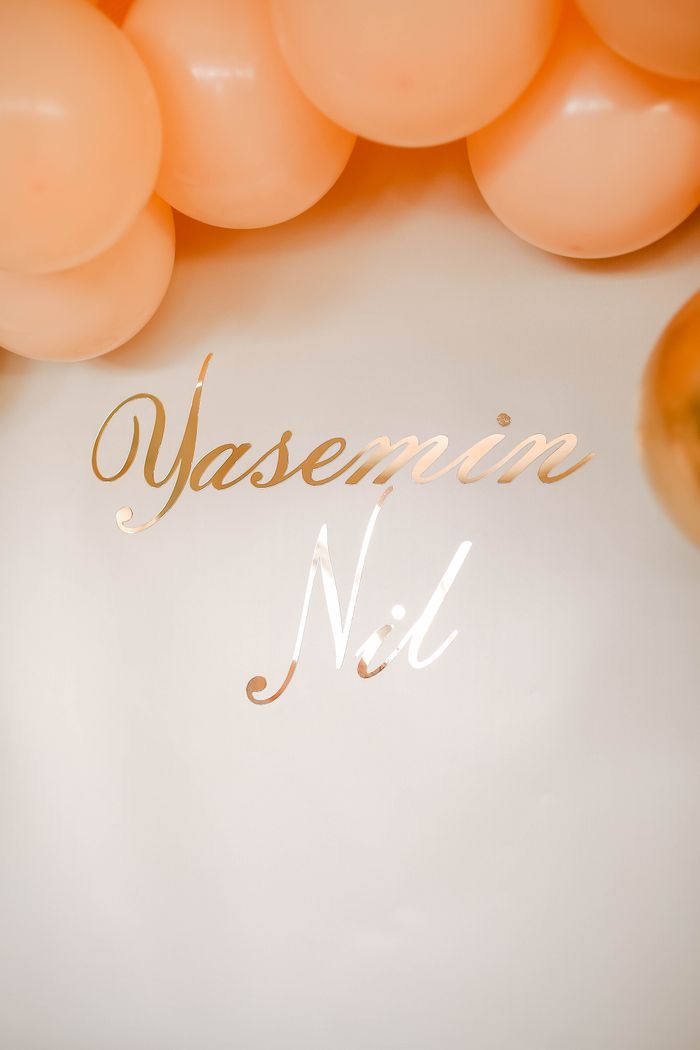 Stylish peach balloon arrangement with reflective text for special events.
