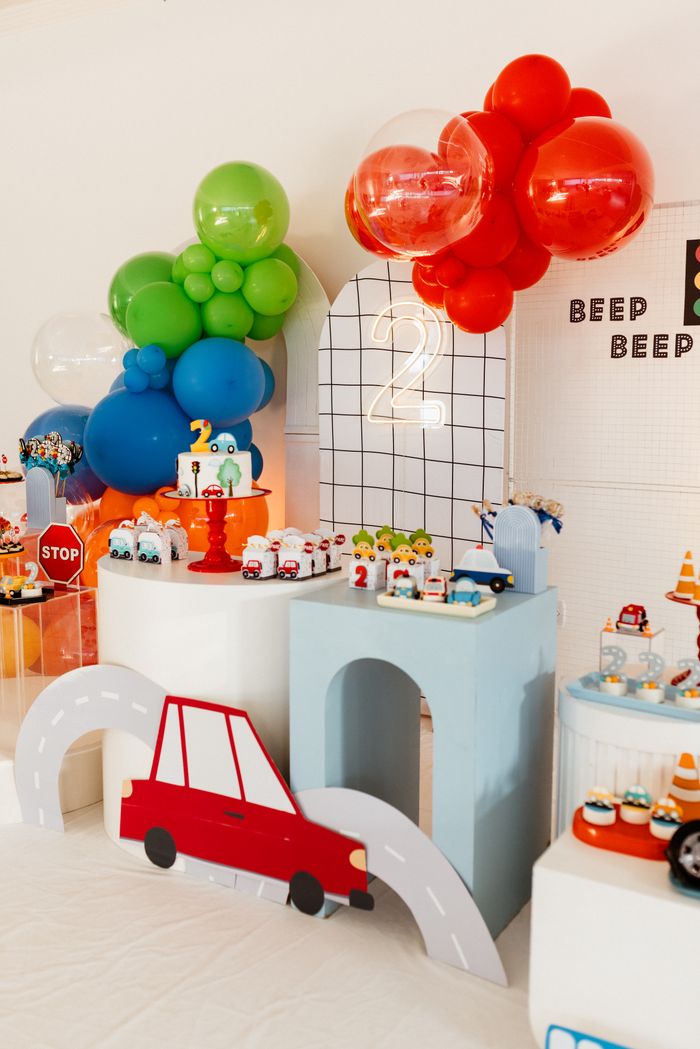 ours-journey Vibrant car-themed birthday party setup with colorful balloons and decorative elements.